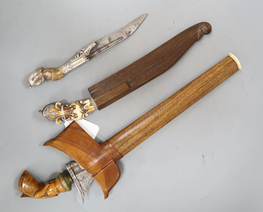 Two Ceylonese knives Pia Kaetta, both with ivory grips and silver mounts and a Malayan dagger kris (3)